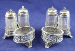 A pair of Victorian pierced silver single handled cruet stands, with beaded borders, on scroll feet,