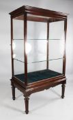 A large mahogany shop display cabinet, with glass sides and two internal glass shelves, with a