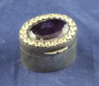 A late 19th/early 20th century continental silver oval pill box, with hinged lid set with a large
