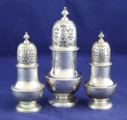 A set of three early George II silver casters, of plain baluster form, with turned finials,