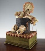 A late 19th century French musical automaton, modelled as a bisque headed child seated in a
