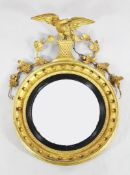 A Regency circular giltwood convex wall mirror, with eagle, acorn and oak leaf crest, H.2ft 8in.