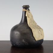 An olive green glass mallet shaped wine bottle, mid 18th century, with sand disc pontil, with
