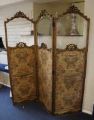 A 19th century French giltwood three fold screen, with part glazed and woven silk panels, within a