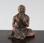 A Chinese bronze seated figure of a Luohan, 3.5in. (9cm)