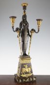 A 19th century French bronze and ormolu Egyptian revival candelabra, modelled as a standing Egyptian