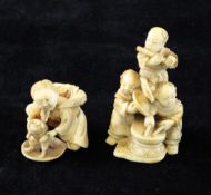 Two Japanese ivory netsuke, Meiji period, the first carved as a boy holding a dog on his hind legs