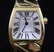 A lady`s 18ct gold Cartier La Dona quartz wrist watch, with shaped silvered Roman dial and facet cut