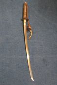 A 20th century Japanese officer`s katana, with ray-skin handle and brown leather covered scabbard,