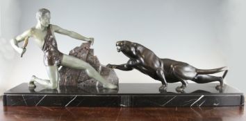 A 1930`s French patinated bronze figure group, of a hunter and panther beside a rock, on rectangular