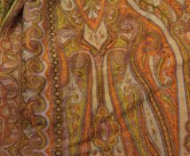 A large 19th century Paisley shawl, decorated with typical stylised floral motifs predominantly on a