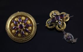 A Victorian gold and almandine garnet set circular brooch, with with starburst decoration and