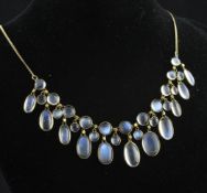 A gold and moonstone fringe necklace, set with graduated oval and round cabochon stones, 24in.