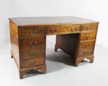 A George III style burr elm pedestal desk, with gilt tooled and brown leather skiver over an