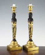 A pair of French bronze and ormolu Empire figural candlesticks, modelled as bearded male figures