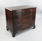 A George III mahogany chest, of two short and three long drawers with brass ring handles, on bracket