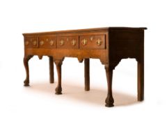 A GEORGE III OAK DRESSER BASE, CIRCA 1760, MID WALES, the twin plank moulded top above four