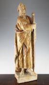 A 17th century European carved wood and polychrome standing figure of a saint, with sword and