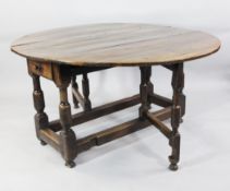 AN ELM AND OAK OVAL GATELEG TABLE, CIRCA 1740, the oval top above lateral drawers, on bold