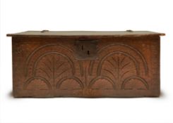A CHARLES II BOARDED OAK BOX, LATE 17TH CENTURY, with an entwined leaf and lunette carved front
