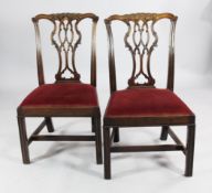 A set of six Chippendale design mahogany dining chairs, with pierced shaped backs, together with two