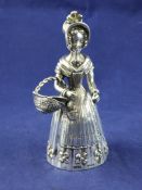 An early 19th century Hanau novelty silver table bell, modelled as a young lady, wearing a bonnet