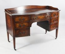 A 19th century bow front mahogany kneehole dressing table, the three quarter gallery, fitted with an