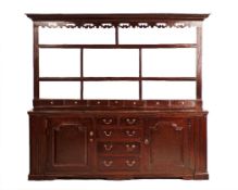A GEORGE III OAK DRESSER, NORTH WEST ENGLAND, CIRCA 1760, the boldly moulded cornice and fret-