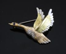 A 1960`s three colour 18ct gold and sapphire set brooch, modelled and a flying goose, 1.75in.