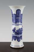 A Chinese blue and white beaker vase, in Kangxi style, painted with birds amid flowers and fruit