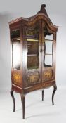 An early 20th century mahogany and floral marquetry inlaid two door display case, the glazed doors