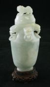 A Chinese jadeite vase and cover, 20th century, of flattened baluster shape, the neck with four lion