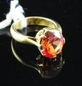 A 22ct gold and solitaire orange sapphire ring, with oval cut stone, size F.