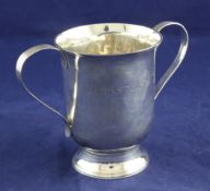 A George III plain silver two handled cup, of cylindrical from with reeded handles and inscribed "