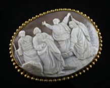 A large gilt metal mounted oval cameo, carved with Christ and three disciples?, with beaded