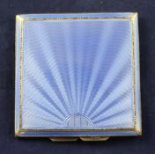 A 1930`s Art Deco engine turned silver and blue guilloche enamel compact, of square form with wavy