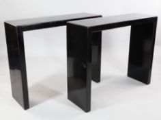 A pair of 20th century ebonised oblong side tables, with slab end supports, W.3ft 3.5in.