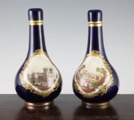 A pair of English porcelain bottles and stoppers, mid 19th century, one painted with a titled view