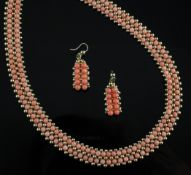 A 14ct gold and coral suite of jewellery, comprising double strand necklace and pair of earrings,