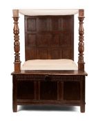 A CHARLES I OAK BED, 17TH CENTURY WITH LATER ELEMENTS, the panelled headboard with oak side rails, a