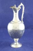 A Victorian silver claret jug, of classical ewer form, with engraved foliate panels and armorial,