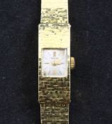 A lady`s 1960`s 18ct gold Tewor manual wind wrist watch, the square dial with baton numerals, on