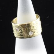 "A 1960`s Kutchinsky diamond set textured 18ct gold ring,