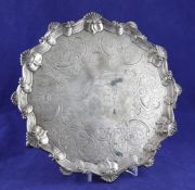 An early George III silver salver, with later engraved foliate decoration of shaped circular form,