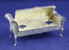 A late 19th century Hanau novelty silver inkstand, modelled as a daybed/chaise longue, embossed with