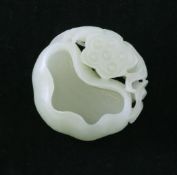 A Chinese pale celadon jade brush washer, carved as a curled lotus leaf and pod with leafy tendrils,