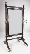 An early 19th century mahogany cheval mirror, with reeded and twist turned uprights and folding