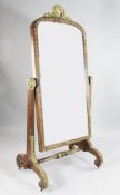 A 19th century French mahogany and gilt gesso decorated cheval mirror, with laurel wreath crest