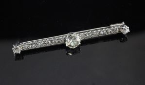 A 1920`s platinum and diamond bar brooch, set with fifteen stones, the central stone weighing