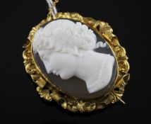 A 15ct gold mounted oval cameo brooch, carved with the head of a maiden to dexter, with ornate